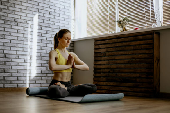 Meditation, woman and lotus pose on living room floor for peace, mental  health and wellness at